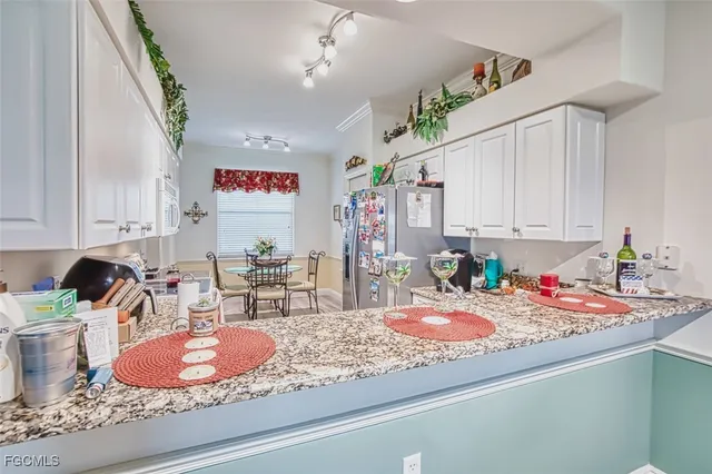 a living room with furniture fireplace and a large window