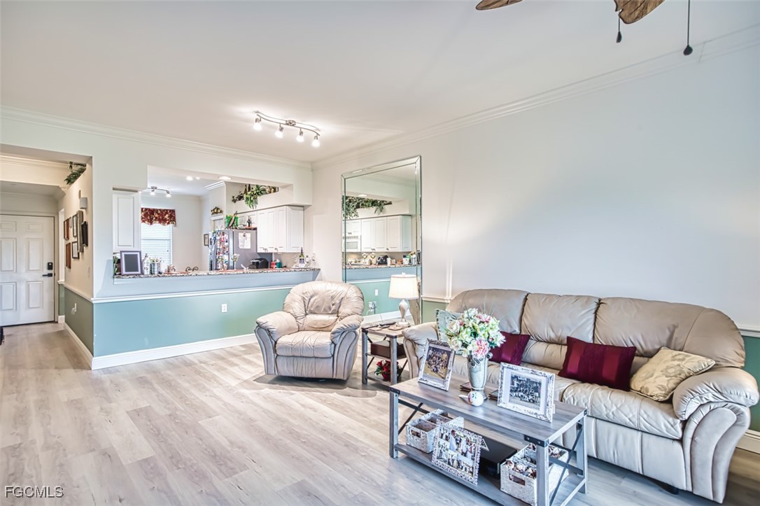 10275 Bismark Palm Way, Unit 1124 Fort Myers, FL 33966 - Photo 18 of 50 a living room with furniture and a large window