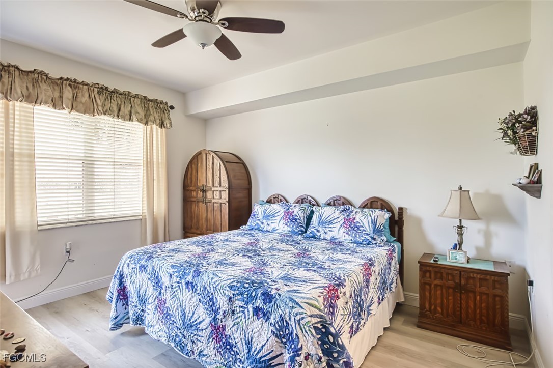10275 Bismark Palm Way, Unit 1124 Fort Myers, FL 33966 - Photo 22 of 50 a bedroom with a bed and a window