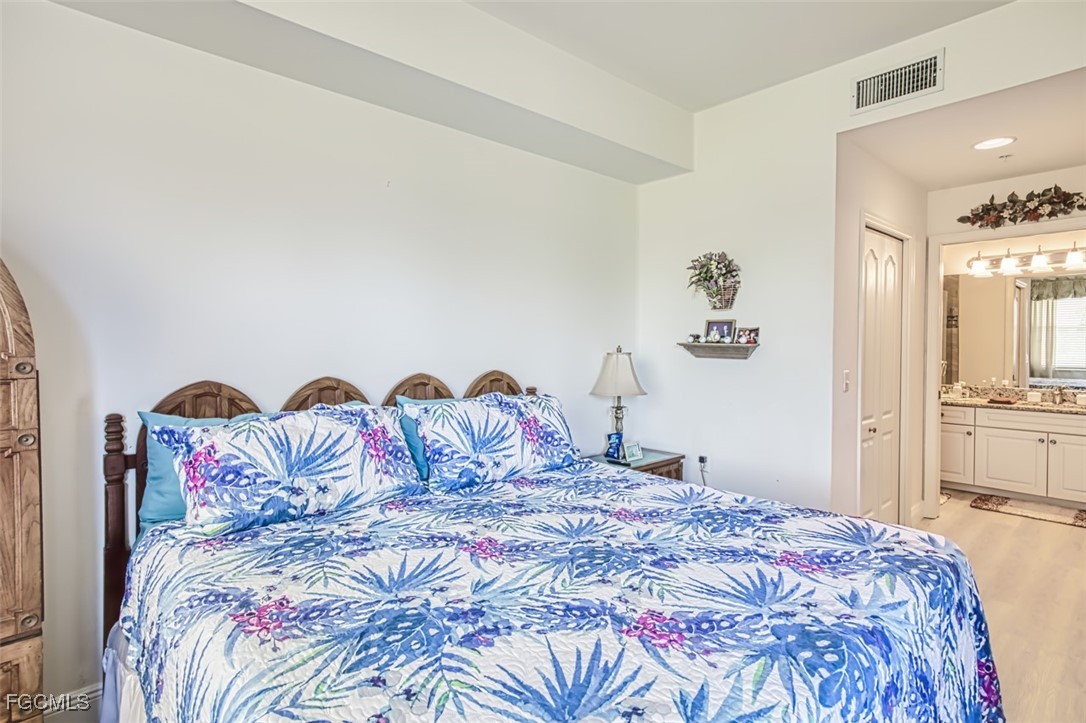 10275 Bismark Palm Way, Unit 1124 Fort Myers, FL 33966 - Photo 23 of 50 a bedroom with a bed and a table in it