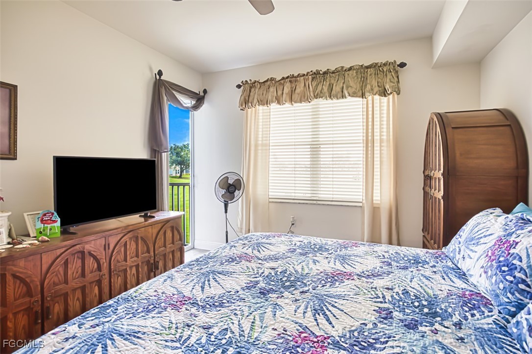 10275 Bismark Palm Way, Unit 1124 Fort Myers, FL 33966 - Photo 24 of 50 a bedroom with bed and flat screen tv