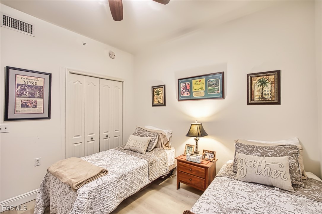 10275 Bismark Palm Way, Unit 1124 Fort Myers, FL 33966 - Photo 29 of 50 a bedroom with a bed and lamp