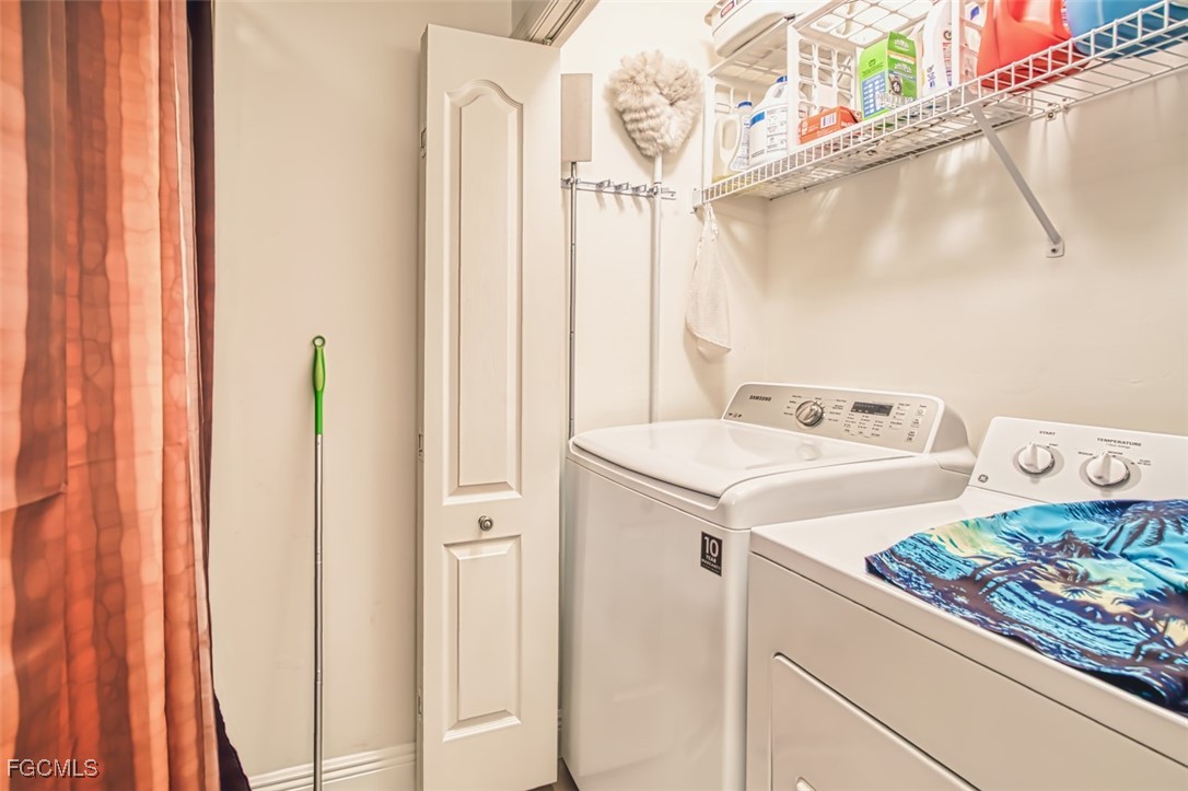 10275 Bismark Palm Way, Unit 1124 Fort Myers, FL 33966 - Photo 32 of 50 a utility room with dryer and washer