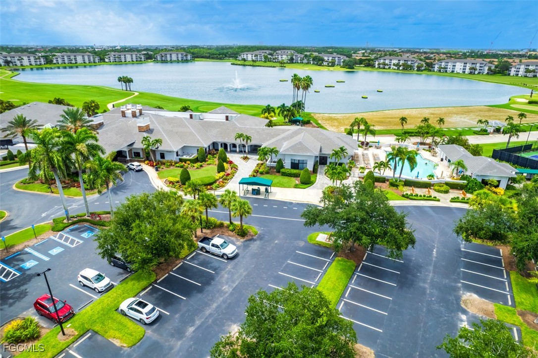 10275 Bismark Palm Way, Unit 1124 Fort Myers, FL 33966 - Photo 35 of 50 a view of a swimming pool with a garden and outdoor seating