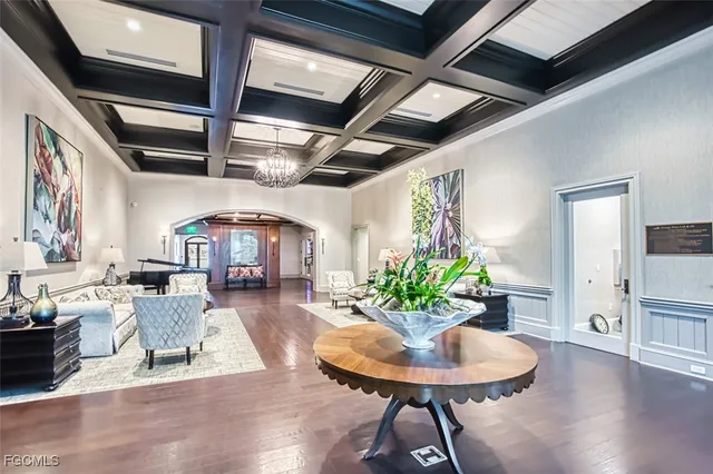 a living room with lots of furniture and kitchen view