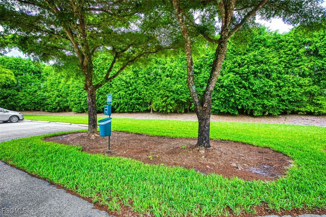 10275 Bismark Palm Way, Unit 1124 Fort Myers, FL 33966 - Photo 46 of 50 a sign board with flower garden in front of it