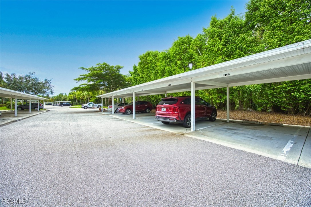 10275 Bismark Palm Way, Unit 1124 Fort Myers, FL 33966 - Photo 49 of 50 a view of a street with a car parked on the road