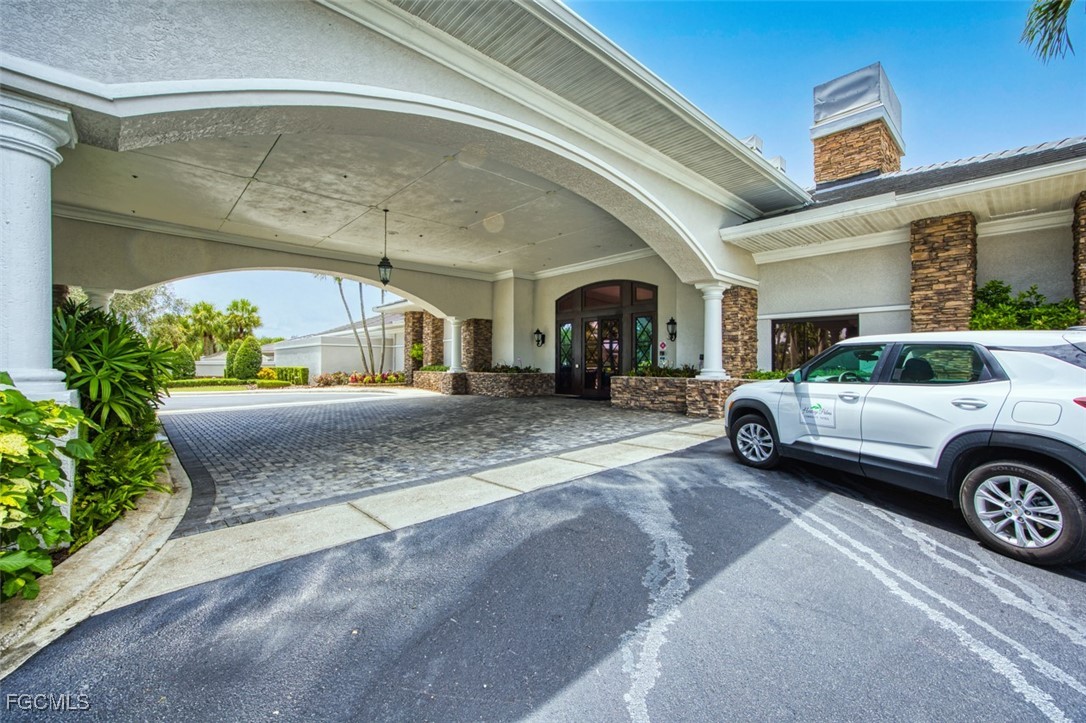 10275 Bismark Palm Way, Unit 1124 Fort Myers, FL 33966 - Photo 50 of 50 a view of a car parked in front of a building