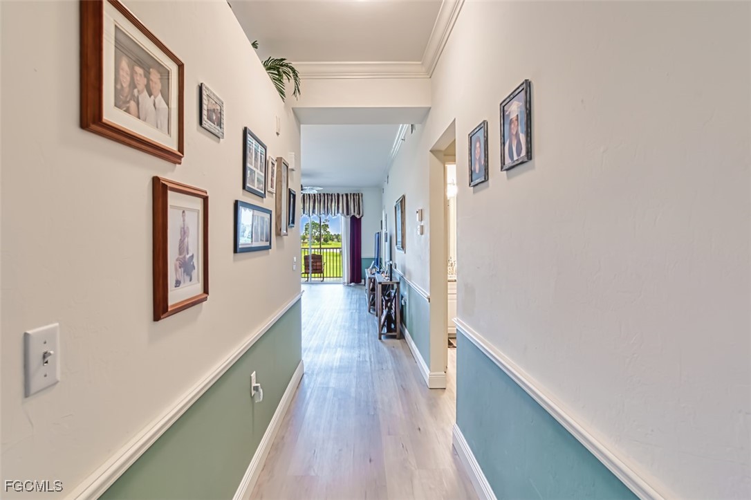 10275 Bismark Palm Way, Unit 1124 Fort Myers, FL 33966 - Photo 6 of 50 a view of a hallway with wooden floor and staircase