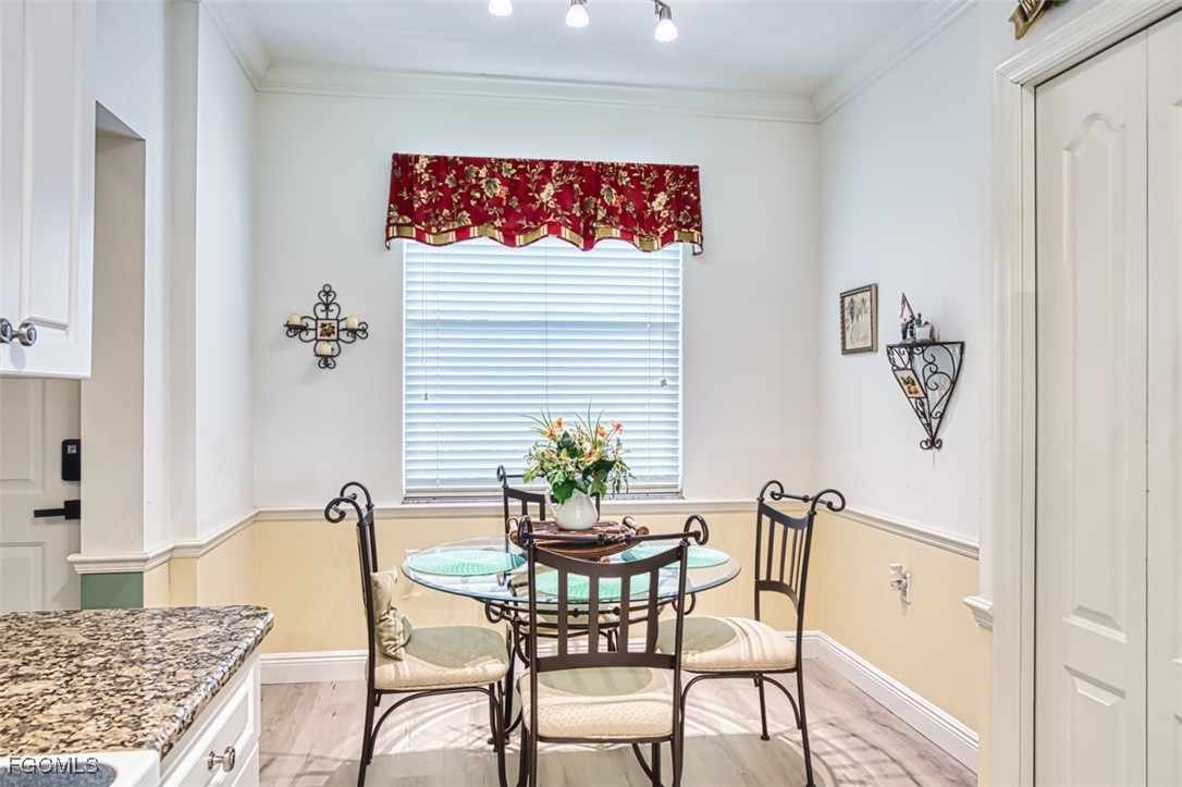10275 Bismark Palm Way, Unit 1124 Fort Myers, FL 33966 - Photo 10 of 50 a view of a dining room with furniture and wooden floor