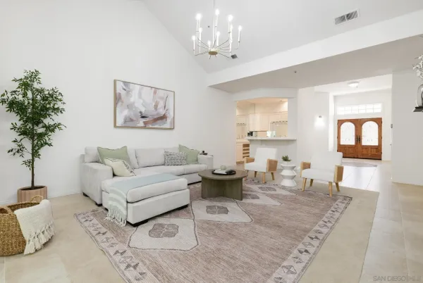 a living room with furniture and a chandelier