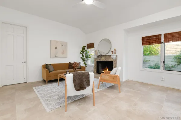 a living room with furniture a window and a fireplace