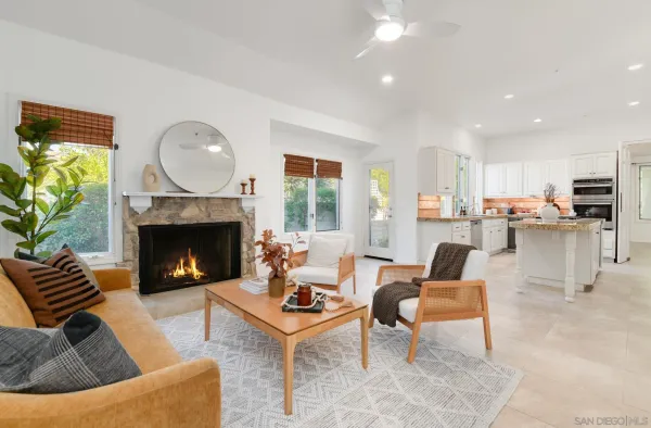a living room with furniture a fireplace and a table