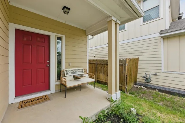 a backyard of a house with barbeque oven table and chairs