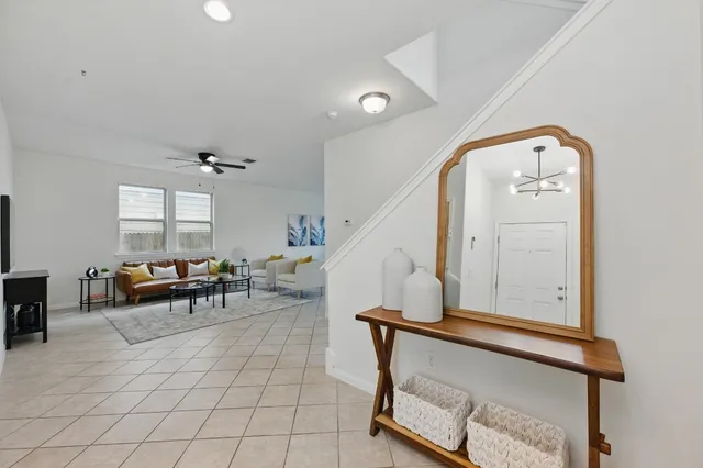 a living room with furniture and a flat screen tv with wooden floor