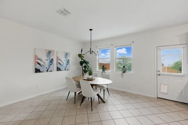 a living room with furniture a flat screen tv and kitchen view
