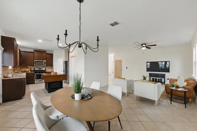 a kitchen with stainless steel appliances granite countertop a stove sink microwave and refrigerator