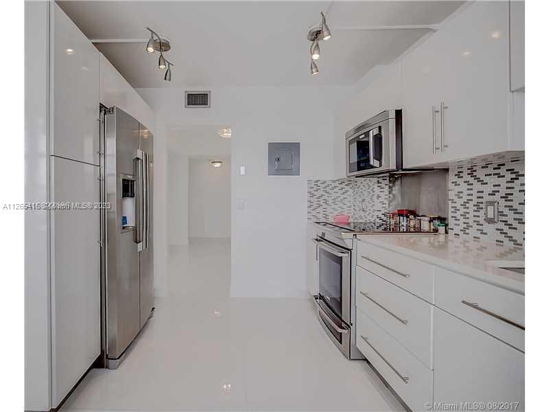 2851 Northeast 183rd Street, Unit 1816E Aventura, FL 33160 - Photo 12 of 29 a kitchen with cabinets and stainless steel appliances