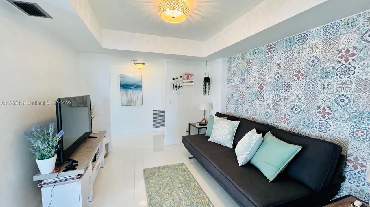 2851 Northeast 183rd Street, Unit 1816E Aventura, FL 33160 - Photo 15 of 29 a living room with furniture and a potted plant