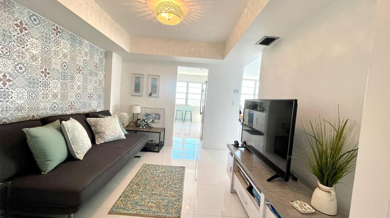 2851 Northeast 183rd Street, Unit 1816E Aventura, FL 33160 - Photo 16 of 29 a living room with furniture and a flat screen tv