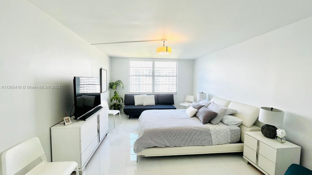 2851 Northeast 183rd Street, Unit 1816E Aventura, FL 33160 - Photo 18 of 29 a living room with furniture and a flat screen tv