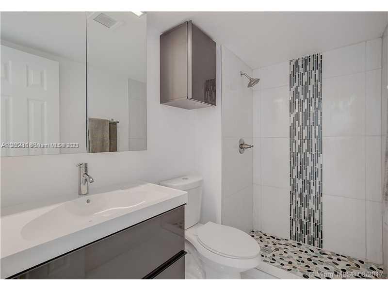 2851 Northeast 183rd Street, Unit 1816E Aventura, FL 33160 - Photo 21 of 29 a bathroom with a sink toilet and shower