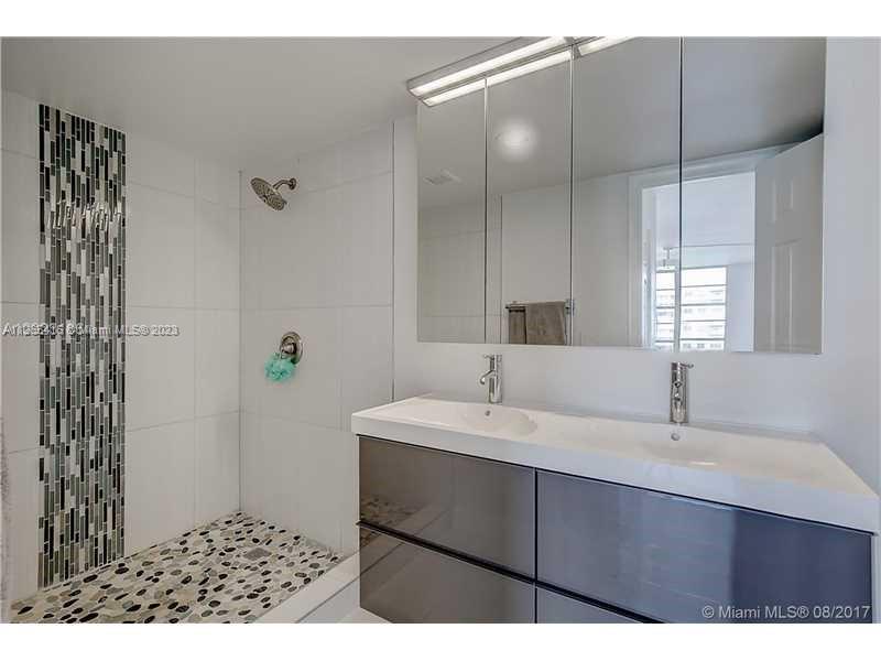 2851 Northeast 183rd Street, Unit 1816E Aventura, FL 33160 - Photo 22 of 29 a bathroom with a sink and a mirror