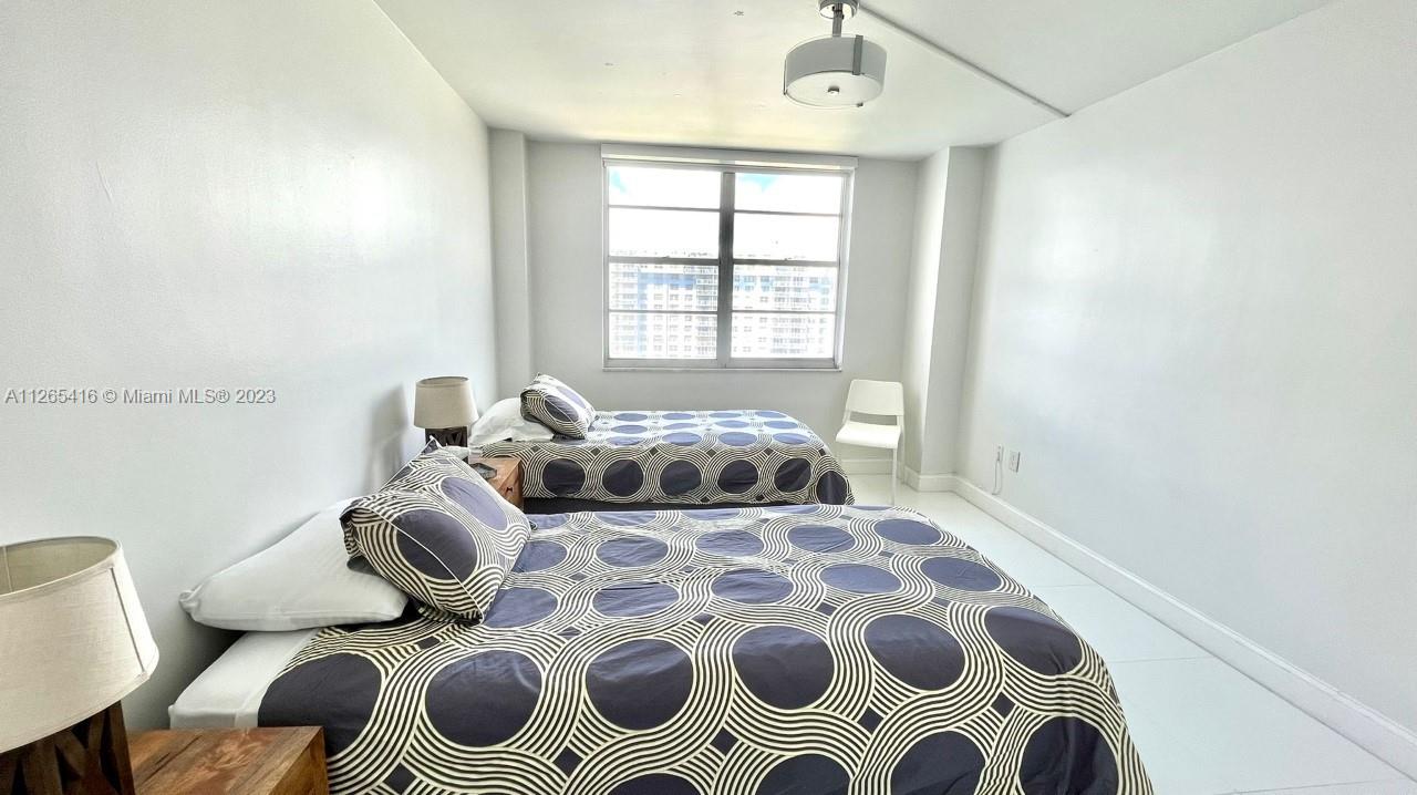 2851 Northeast 183rd Street, Unit 1816E Aventura, FL 33160 - Photo 23 of 29 a bedroom with furniture and a window