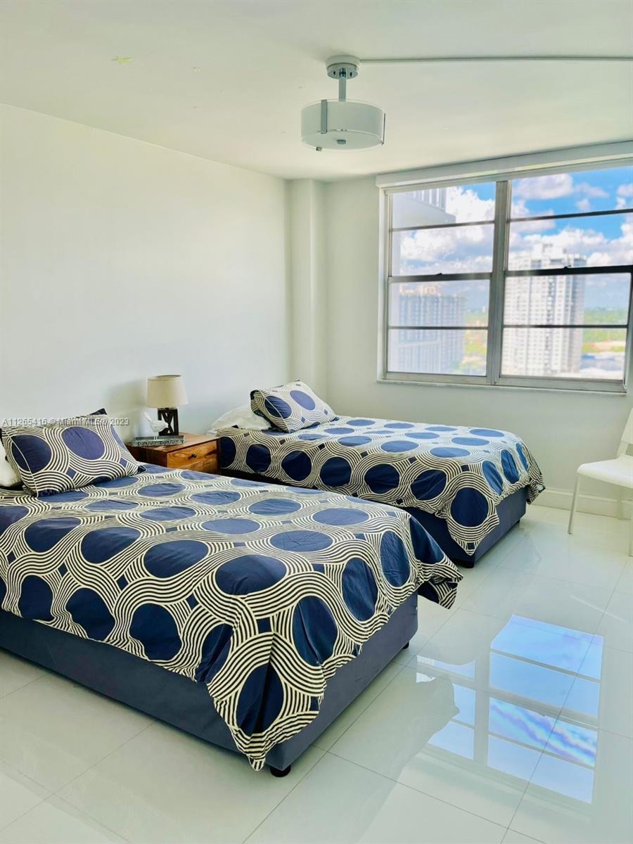 2851 Northeast 183rd Street, Unit 1816E Aventura, FL 33160 - Photo 24 of 29 a bedroom with bed and a window