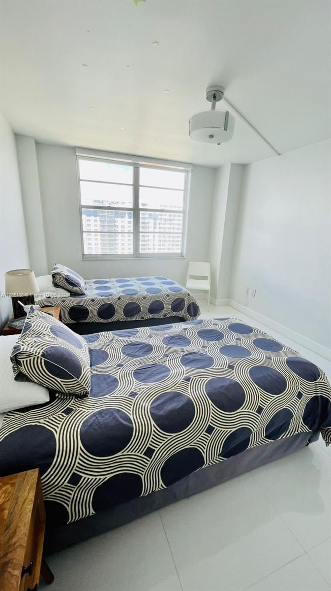 2851 Northeast 183rd Street, Unit 1816E Aventura, FL 33160 - Photo 25 of 29 a kitchen with a stove and a white wooden cabinets
