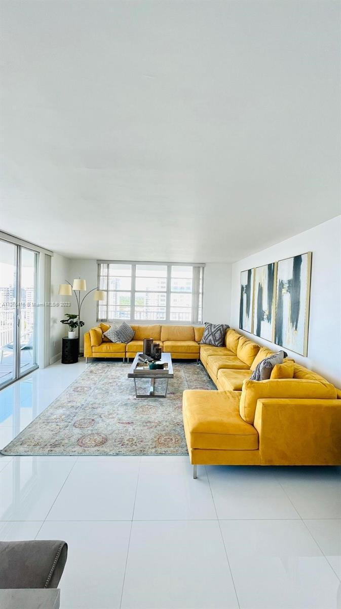 2851 Northeast 183rd Street, Unit 1816E Aventura, FL 33160 - Photo 4 of 29 a living room with furniture and a table