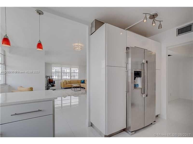 2851 Northeast 183rd Street, Unit 1816E Aventura, FL 33160 - Photo 10 of 29 a kitchen with stainless steel appliances kitchen island a refrigerator sink and cabinets