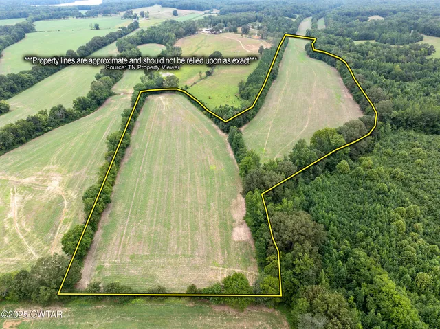 an aerial view of a residential houses with outdoor space and pool