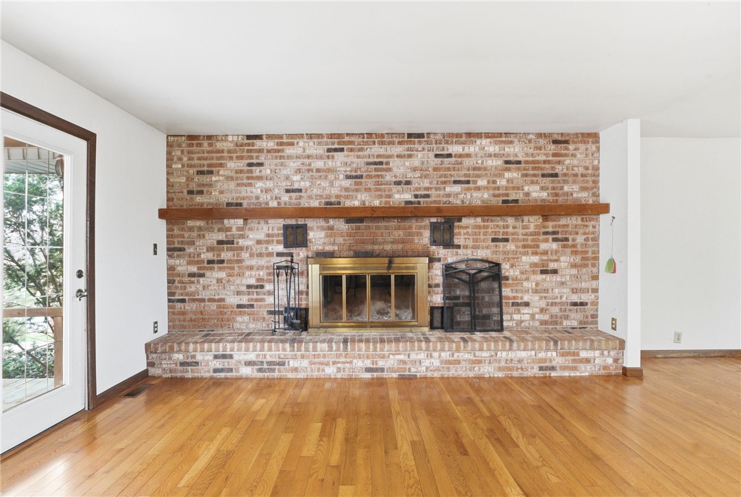 6711 Hamilton-Middletown Road Franklin, OH 45005 - Photo 12 of 49 This inviting living area features a grand brick fireplace, a rich hardwood floor, and abundant natural light.