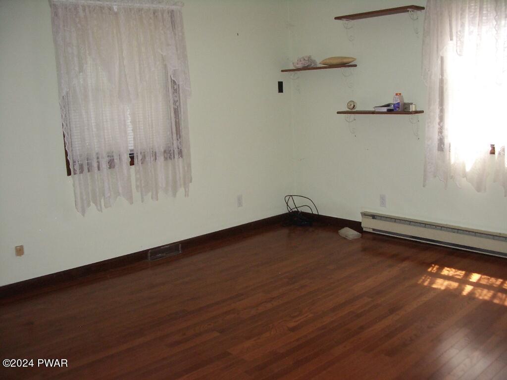 81 Tuthill Road Waymart, PA 18472 - Photo 15 of 29 an empty room with wooden floor and windows