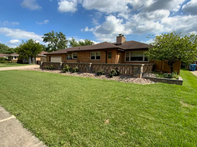 a front view of house with yard and trees