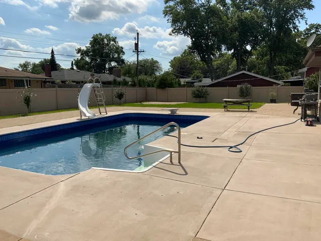 a view of swimming pool with chairs