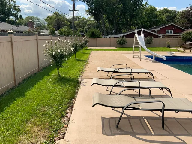 a view of a swimming pool with lounge chairs
