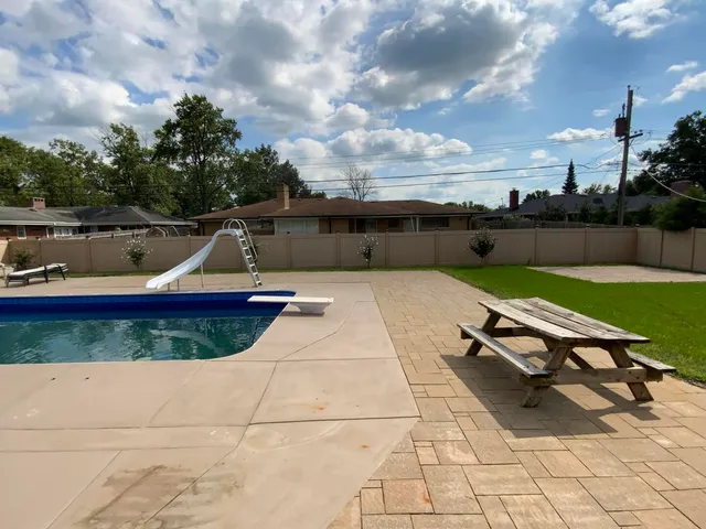a view of a backyard with sitting area
