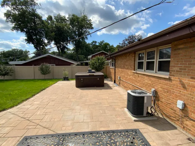 a roof deck with table and chairs