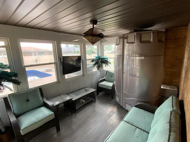 a living room with furniture a dining table and wooden floor