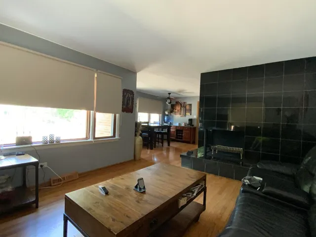 a living room with furniture a rug and a window