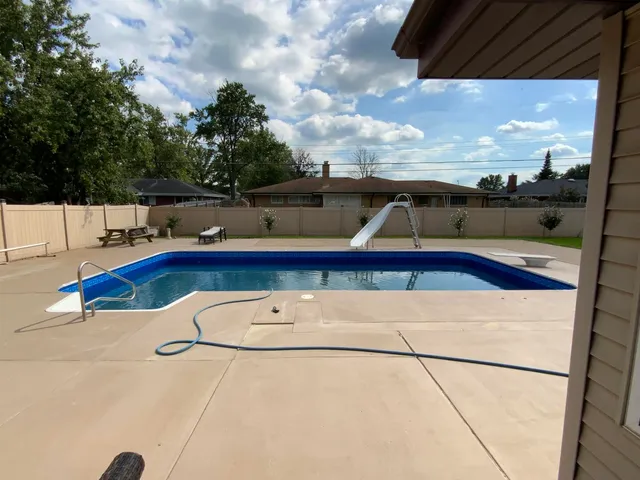 a living room with furniture dining table wooden floor and a window