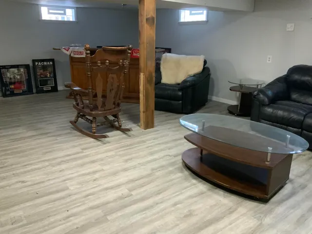 a room with a wooden floor and a fireplace