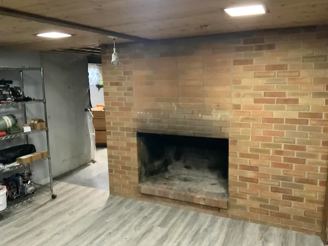 a view of a room with furniture and wooden floor