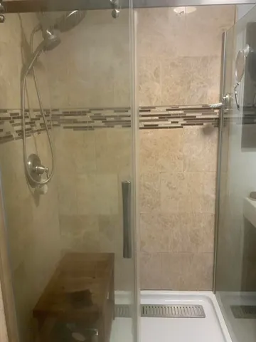 a bathroom with a sink a mirror and shower
