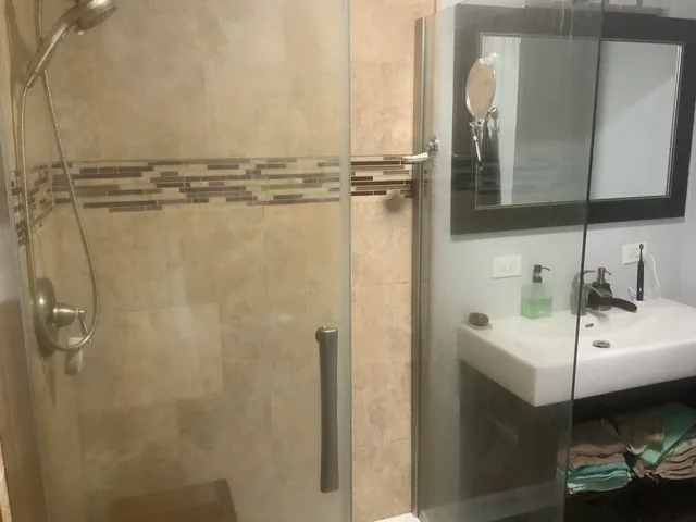 a bathroom with a sink a toilet and shower