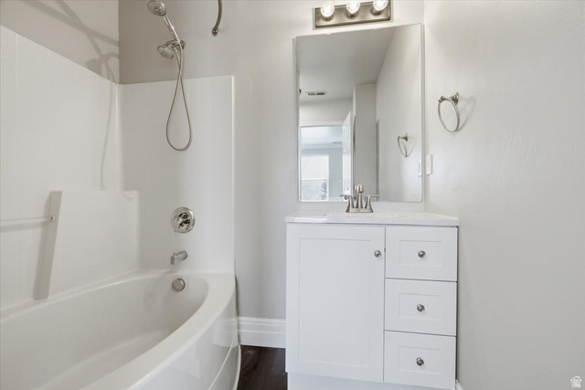 4496 West 11800 South South Jordan, UT 84009 - Photo 14 of 33 Bathroom featuring shower / bathtub combination, vanity, and dark wood-style flooring