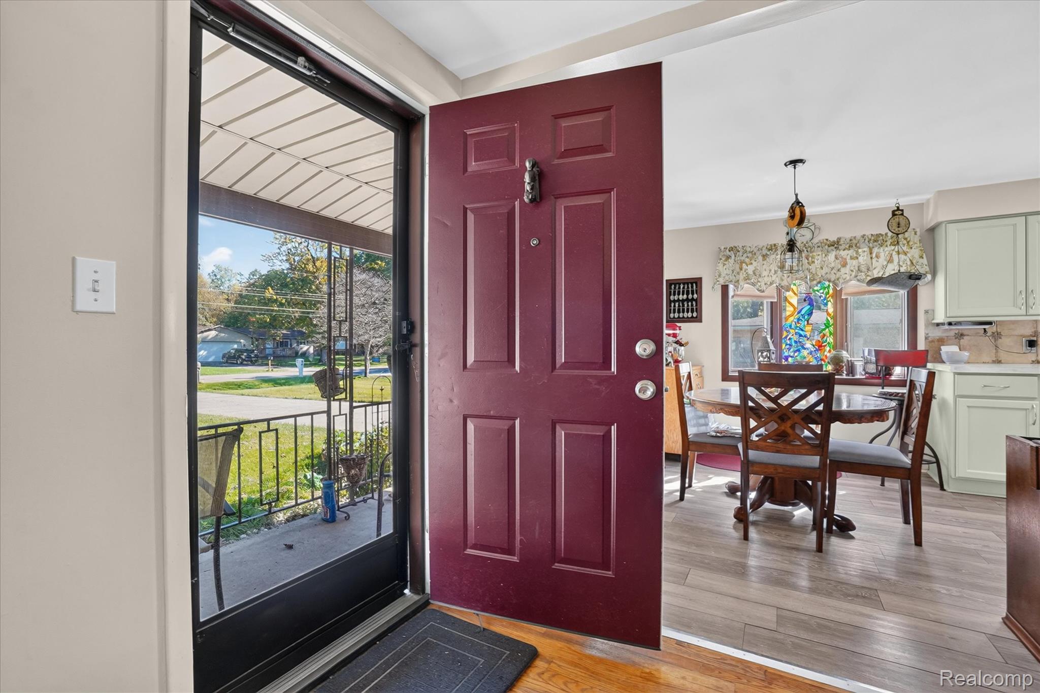 7178 Riegler Street Grand Blanc, MI 48439 - Photo 3 of 31 Entryway featuring a rich burgundy panel door and a full-light storm door