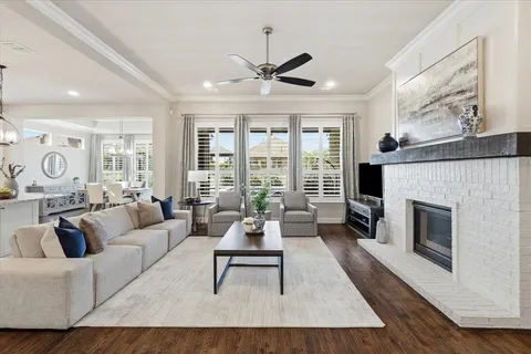 a living room with furniture a large window and a fireplace